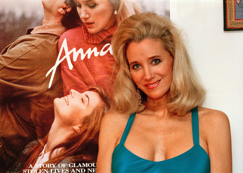 FILE - Sally Kirkland stands next to a poster of her film "Anna" in Los Angeles on Feb. 9, 1988. (AP Photo/Mark Terrill, File)