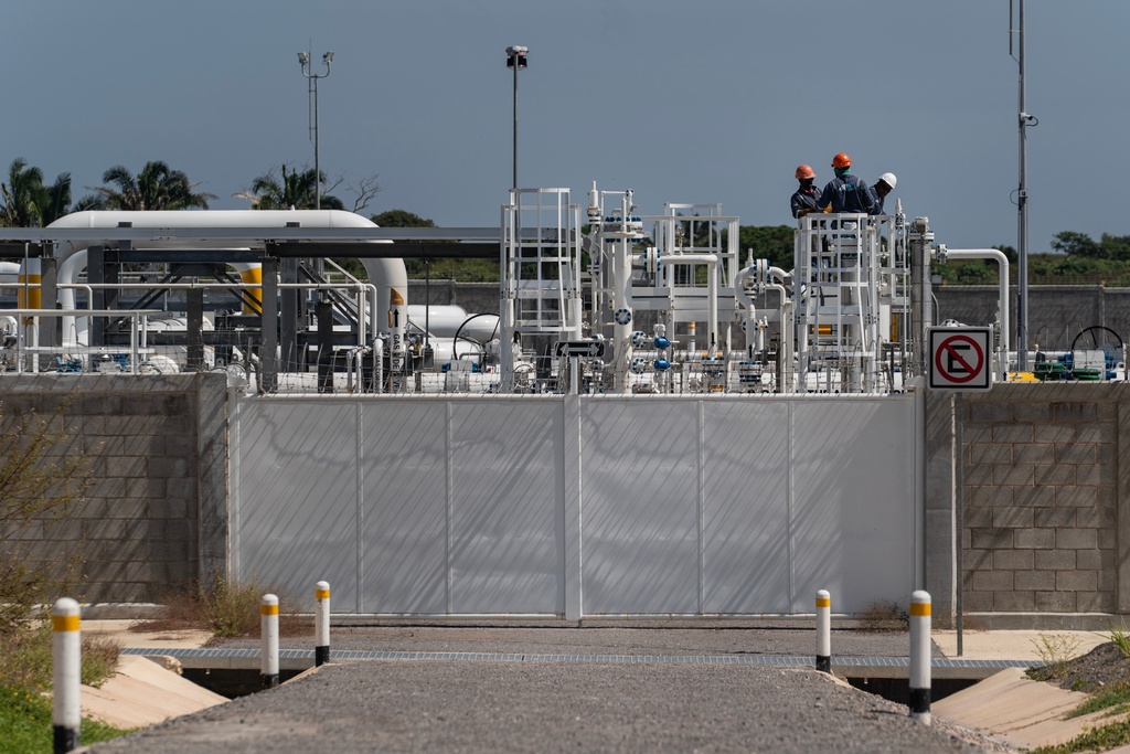 Workers are visible at a compressor station for the Southeast Gateway natural gas pipeline operates in Coatzacoalcos, Mexico, Oct. 28, 2025. (AP Photo/Felix Marquez)