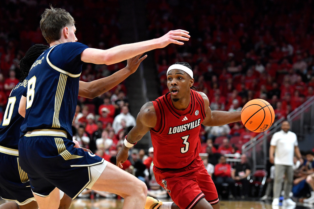 Louisville guard Ryan Conwell (3) drives against Georgia Tech center Cole Kirouac (8) during the second half of an NCAA college basketball game in Louisville, Ky., Saturday, Feb. 21, 2026. (AP Photo/Timothy D. Easley)