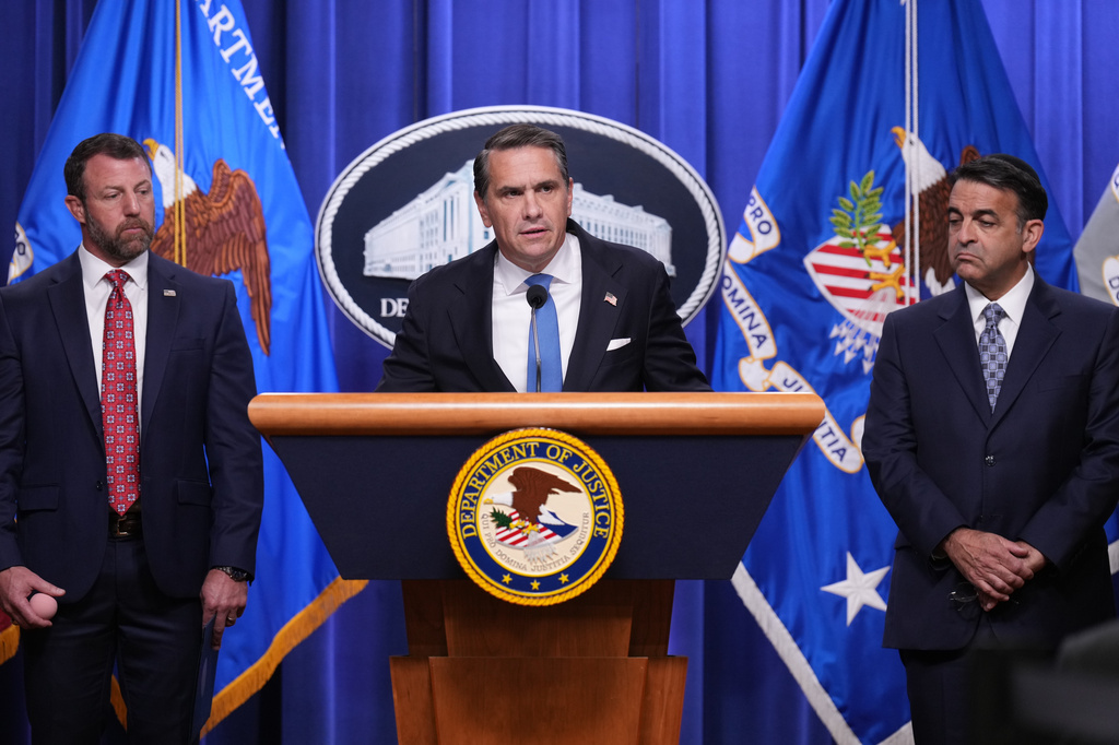 Attorney General Todd Blanche speaks during a news conference at the Department of Justice, Wednesday Sept. 30, 2026, in Washington, as Secretary of Homeland Security Markwayne Mullin and Daniel Rosen, U.S. Attorney for the District of Minnesota, look on. (AP Photo/Jacquelyn Martin)