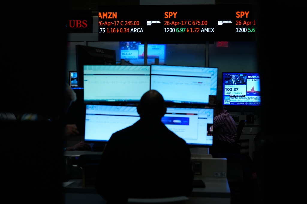 Traders work on the floor at the New York Stock Exchange in New York, Monday, April 13, 2026. (AP Photo/Seth Wenig)