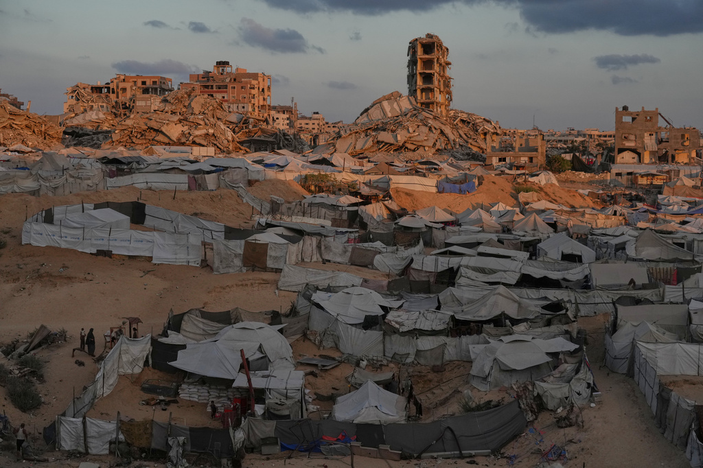 Tents sheltering displaced Palestinians are seen amid war-damaged buildings in Gaza City, Saturday, Sept. 26, 2026. (AP Photo/Jehad Alshrafi)