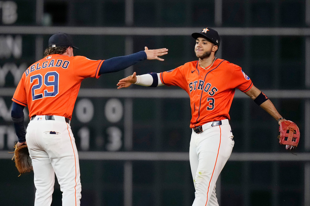 Houston Astros second baseman Raynel Delgado (29) and shortstop Jeremy Peña (3) celebrate after a baseball game against the Cleveland Guardians, Friday, June 19, 2026, in Houston. (AP Photo/Kevin M. Cox)
