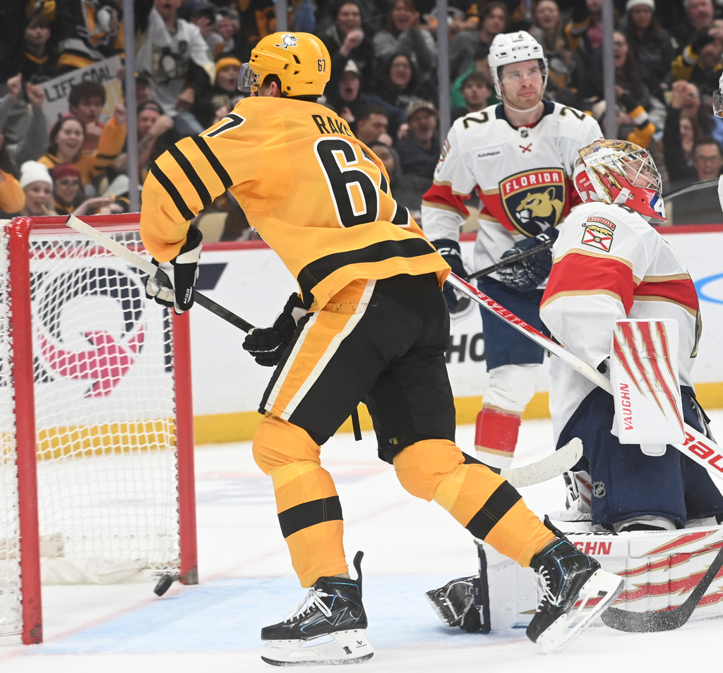 Pittsburgh Penguins right wing Rickard Rakell (67) scores on Florida Panthers goalie Daniil Tarasov (40) during the second period of an NHL hockey game, Sunday, April 5, 2026, in Pittsburgh. (AP Photo/Philip G. Pavely)
