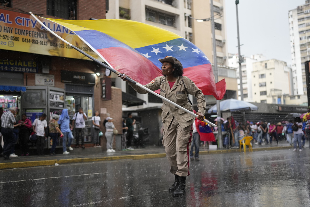 Government supporters rally to mark the anniversary of the 1958 coup that overthrew Venezuelan dictator Marcos Pérez Jiménez in Caracas, Venezuela, Friday, Jan. 23, 2026. (AP Photo/Ariana Cubillos)