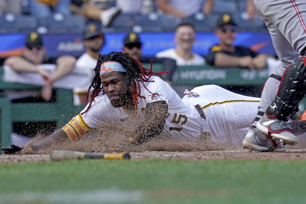 Pittsburgh Pirates' Oneil Cruz scores during the eighth inning of a baseball game against the Cincinnati Reds, Sunday, Aug. 10, 2025, in Pittsburgh. (AP Photo/Matt Freed)