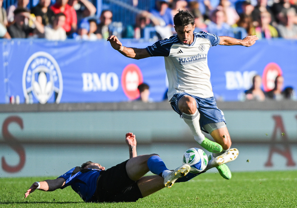 CF Montreal's Luca Petrasso, bottom, slides in against Nashville SC's Gaston Brugman, top, during the second half of an MLS soccer game in Montreal, Saturday, Oct. 4, 2025. (Graham Hughes/The Canadian Press via AP)