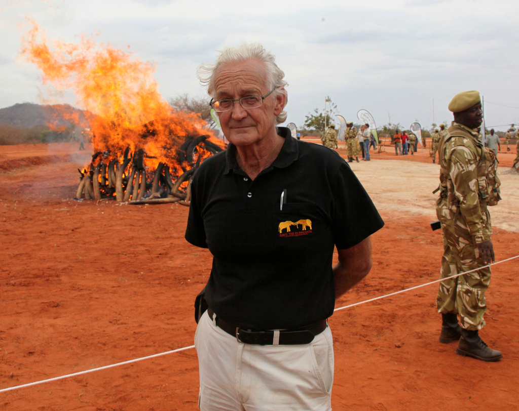 FILE - Iain Douglas-Hamilton, founder of Save the Elephants, poses in front of confiscated ivory at Kenya Wildlife Training School, Manyani, Kenya, Wednesday, July 20, 2011. (AP Photo/Sayyid Azim)