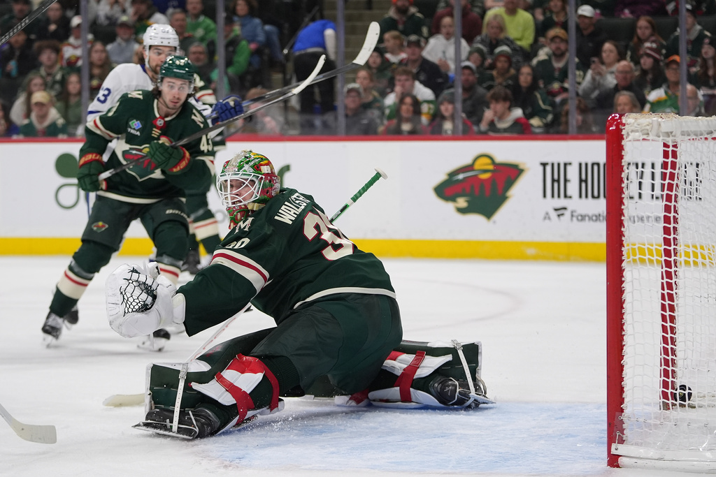 Minnesota Wild goaltender Jesper Wallstedt, right, gives up a goal to Toronto Maple Leafs center Bo Groulx during the second period of an NHL hockey game, Sunday, March 15, 2026, in St. Paul, Minn. (AP Photo/Abbie Parr)