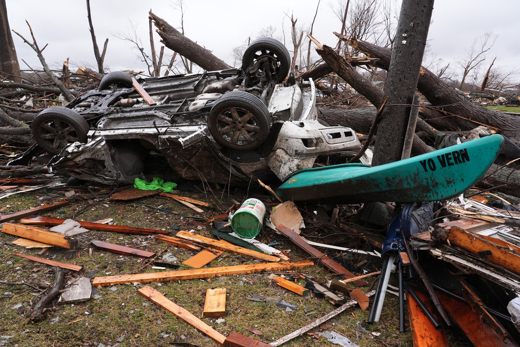 A damaged vehicle lies upside down amid debris in the aftermath of a powerful storm that ripped through the area a day earlier, in Aroma Park, Ill., Wednesday, March 11, 2026. (AP Photo/Nam Y. Huh)