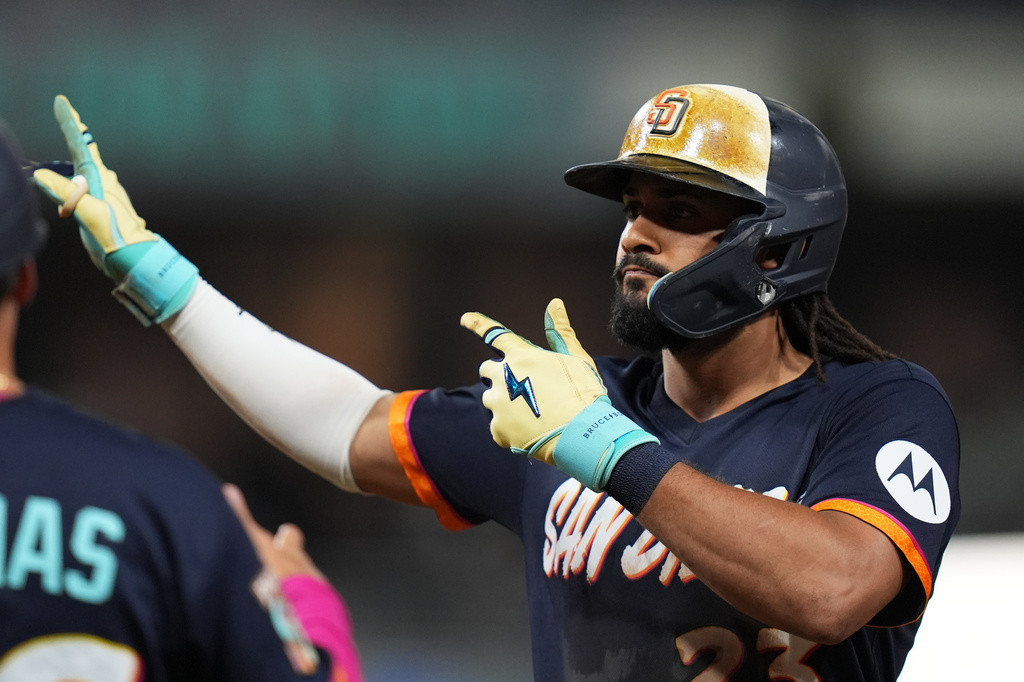 San Diego Padres' Fernando Tatis Jr. celebrates after hitting an RBI single during the fifth inning of a baseball game against the Minnesota Twins Friday, Aug. 21, 2026, in San Diego. (AP Photo/Gregory Bull)