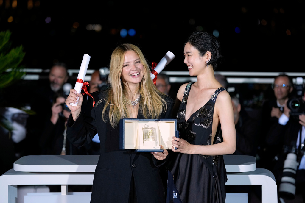 Virginie Efira, left, and Tao Okamoto, winners of the award for best actress for 'All of a Sudden,' pose for photographers at the awards ceremony photo call during the 79th international film festival, Cannes, southern France, Saturday, May 23, 2026. (AP Photo/John Locher)