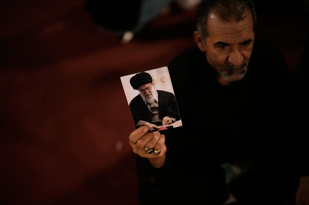 A man holds a picture of the late Iranian Supreme Leader Ayatollah Ali Khamenei on the eve of funeral ceremonies in Karbala, Iraq, Tuesday, July 7, 2026, as the dayslong funeral ceremonies continue in Iraq with events in the Shiite holy cities of Karbala and Najaf. (AP Photo/Khalil Hamra)