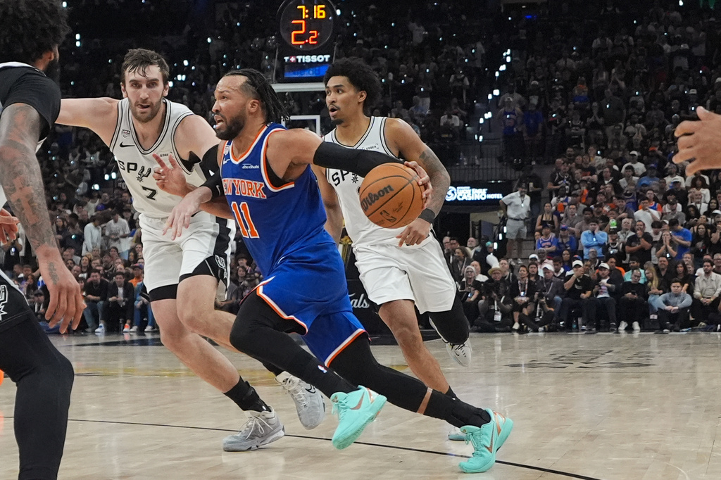 New York Knicks guard Jalen Brunson (11) drives as San Antonio Spurs center Luke Kornet (7) defends during the second half of Game 5 of the NBA Finals basketball series, Saturday, June 13, 2026, in San Antonio. (AP Photo/Ross D. Franklin)