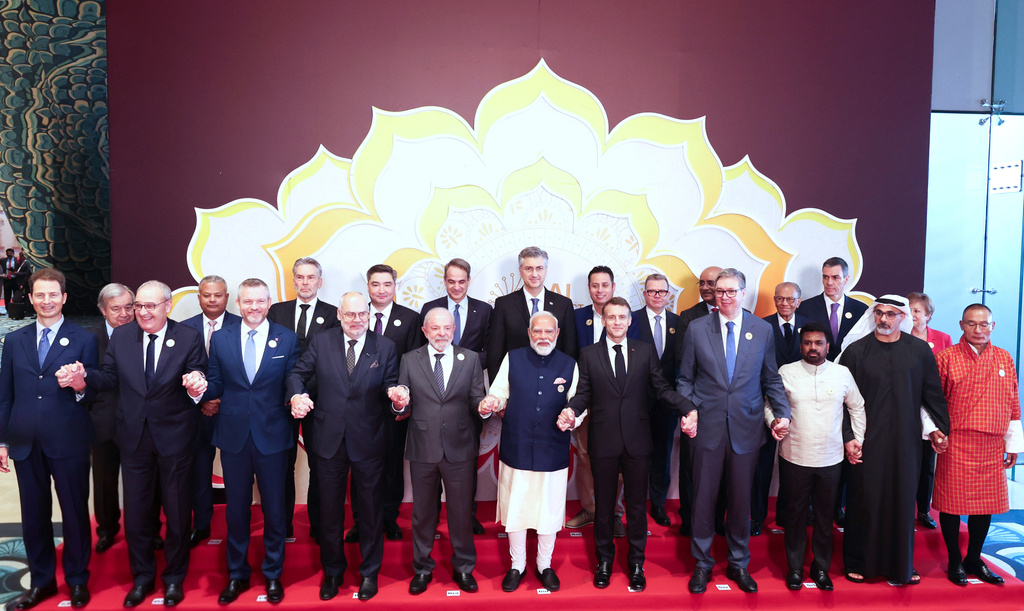 India's Prime Minister Narendra Modi, center, hold hands and poses for photographs with various head of states of participating countries during the AI Summit in New Delhi, India, Thursday, Feb. 19, 2026. (Indian Prime Minister's Office via AP)