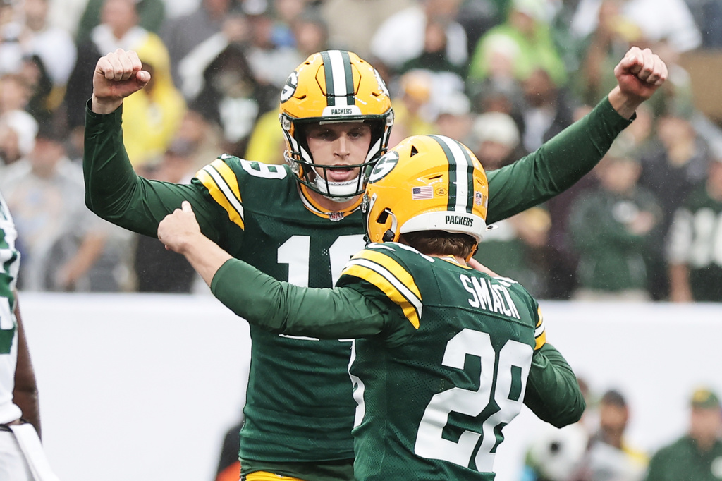 Green Bay Packers punter Daniel Whelan (19) and Packers kicker Trey Smack (28) celebrate the game-winning field goal during an NFL football game against the New York Jets in East Rutherford, N.J., Sunday, Sept. 20, 2026. (AP Photo/Adam Hunger)
