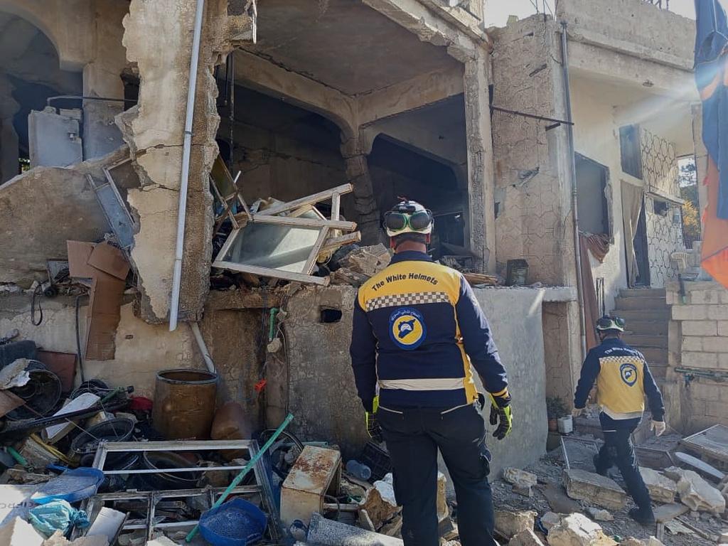 This photo provided by the Syrian Civil Defense, White Helmets, Syrian Civil Defense workers check a house that was destroyed during an Israeli forces raid in the southern Syrian village of Beit Jin, Syria, Friday, Nov. 28, 2025. (Syrian Civil Defense White Helmets via AP)