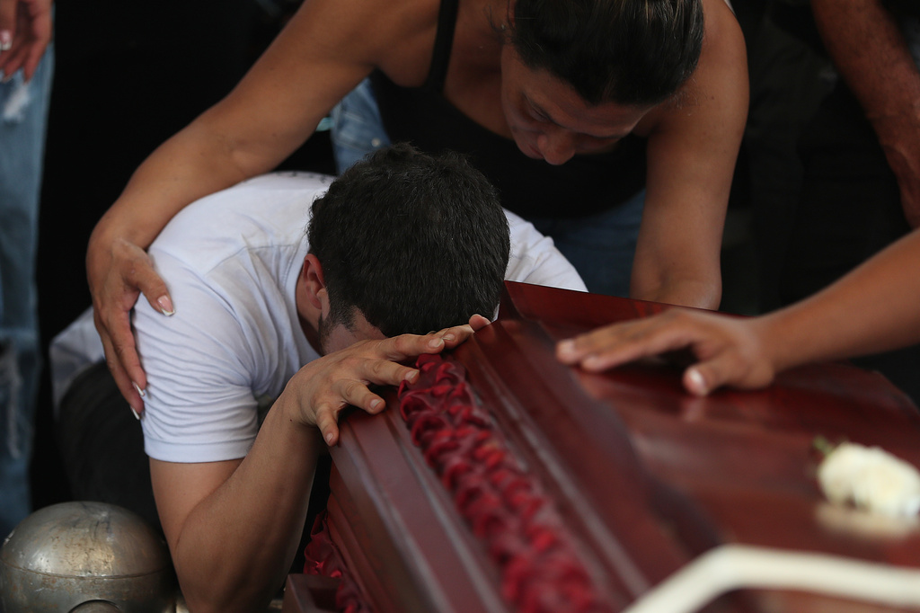 Relative mourn during the funeral of Lorena Restrepo who died at her home when an earthquake hit Cali, Colombia, Friday, Aug. 14, 2026. (AP Photo/Santiago Saldarriaga)