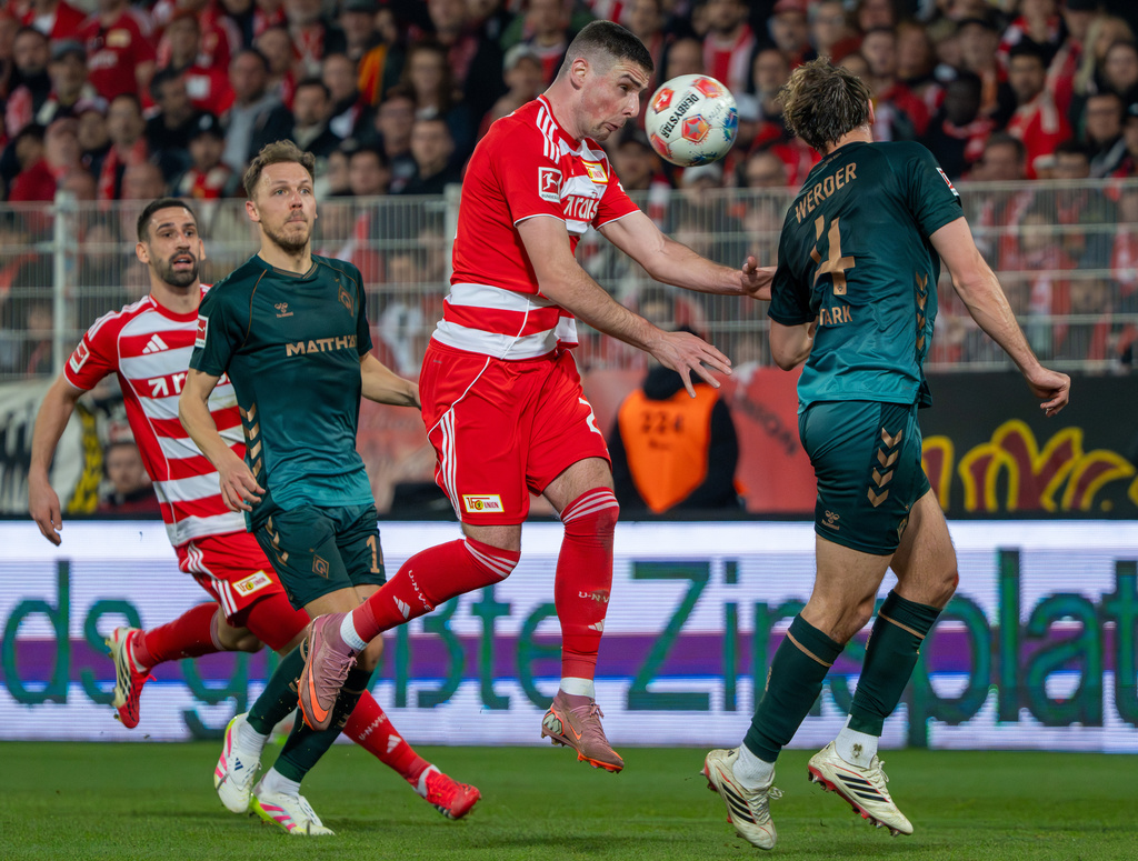 Union Berlin's Andrej Ilic and Bremen's Niklas Stark, right, in action during the German Bundesliga soccer game between Union Berlin and Werder Bremen in Berlin, Germany, Sunday, March 8, 2026. (Soeren Stache/dpa via AP)