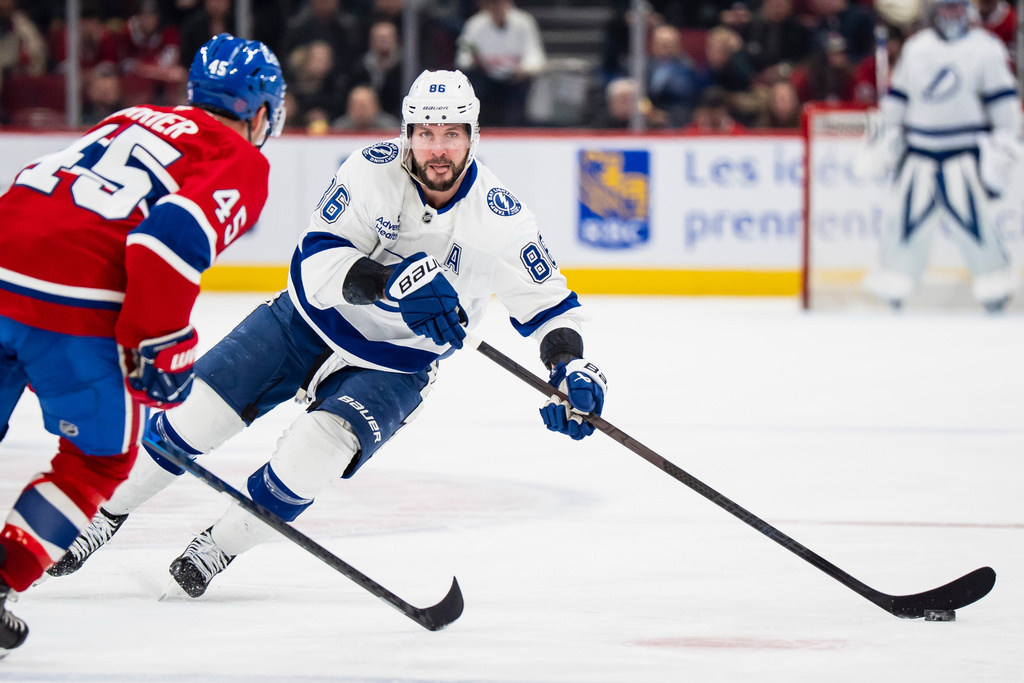 Tampa Bay Lightning' Nikita Kucherov (86) skates with the puck while Montreal Canadiens' Alexandre Carrier (45) defends during the second period of an NHL hockey game, in Montreal, Tuesday, Dec. 9, 2025. (Christopher Katsarov/The Canadian Press via AP)