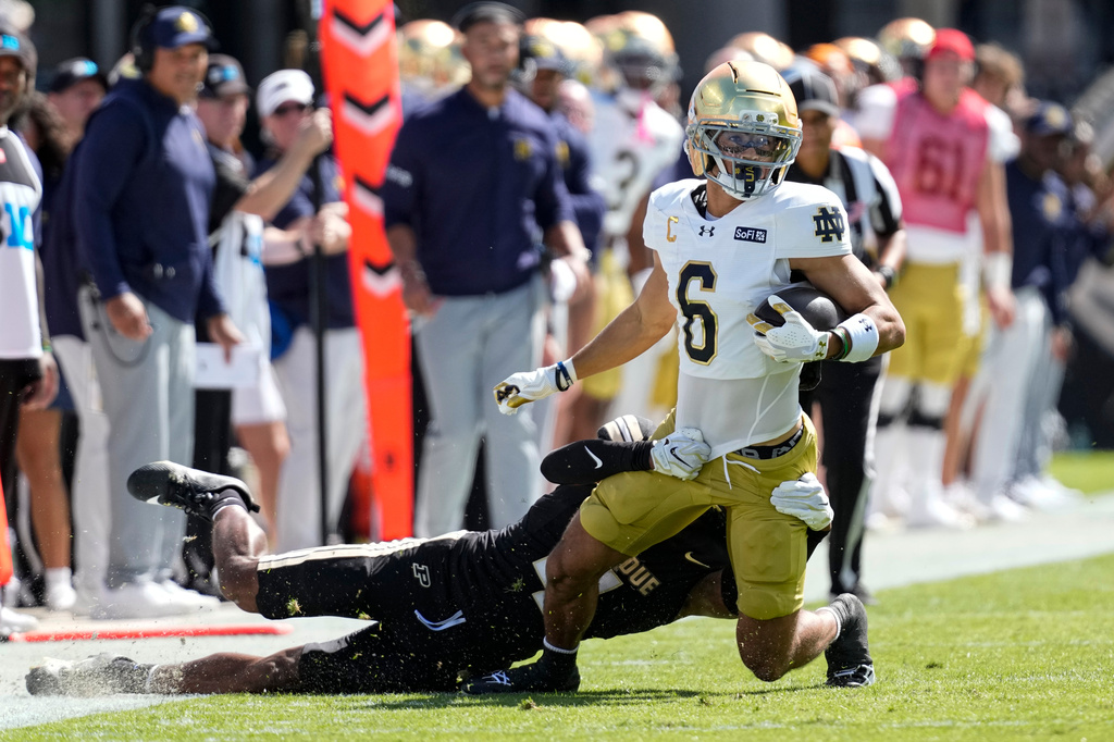 Notre Dame wide receiver Jordan Faison (6) is tackled by Purdue defensive back Hudauri Hines (4) during the first half of an NCAA college football game in West Lafayette, Ind., Saturday, Sept. 26, 2026. (AP Photo/Michael Conroy)