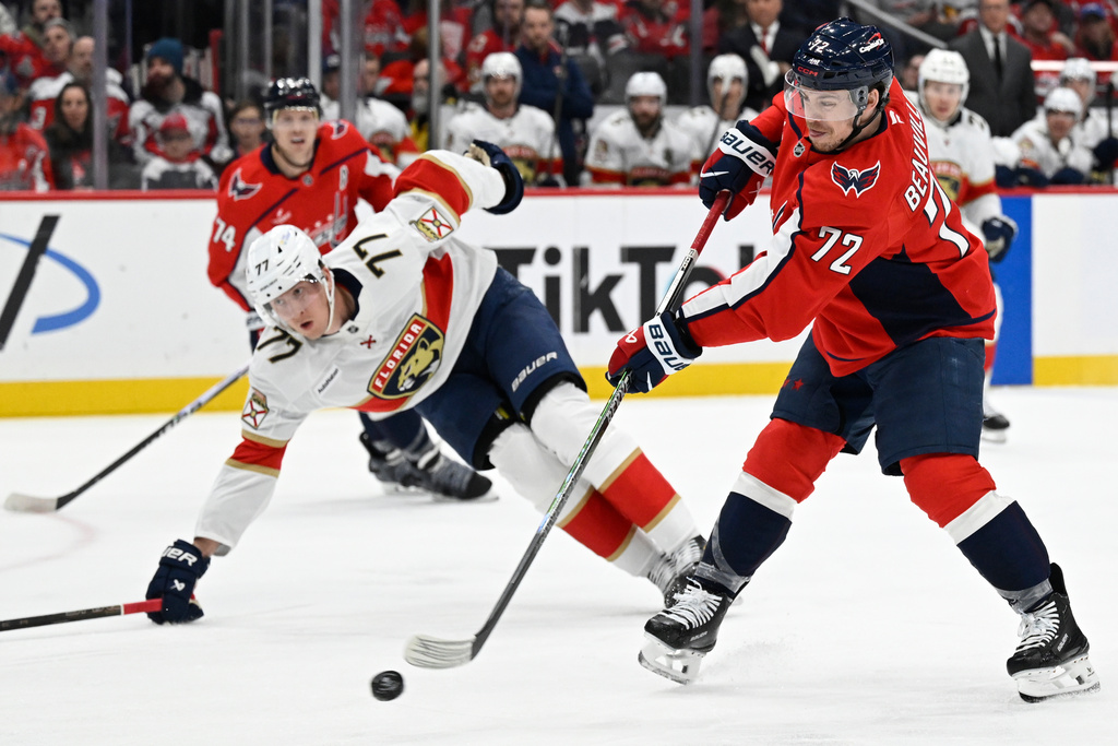 Washington Capitals left wing Anthony Beauvillier (72) shoots against Florida Panthers defenseman Niko Mikkola (77) during the first period of an NHL hockey game, Saturday, Jan. 17, 2026, in Washington. (AP Photo/John McDonnell)
