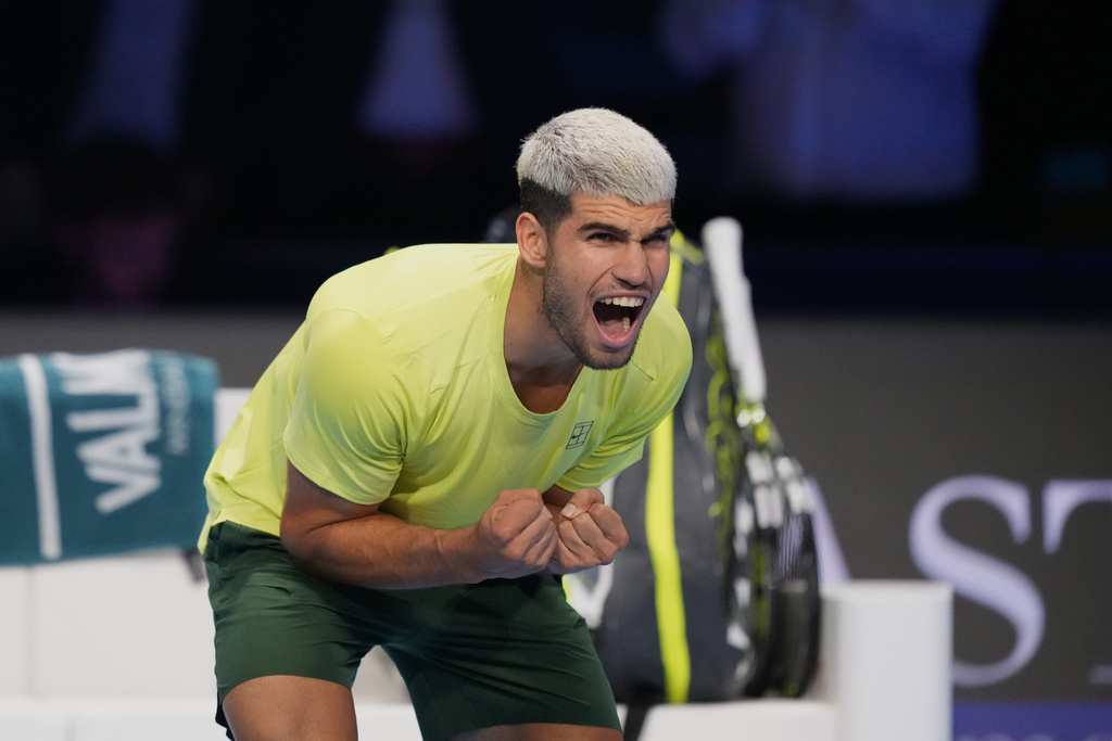 Spain's Carlos Alcaraz celebrates after winning against Italy's Lorenzo Musetti during the tennis match of the ATP World Tour Finals, in Turin, Italy, Thursday, Nov. 13, 2025. (AP Photo/Antonio Calanni)