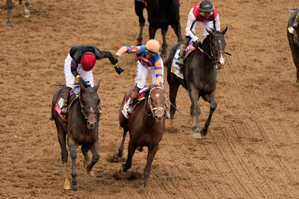 Jockey Jose L. Ortiz, left, is congratulated by Irad Ortiz, Jr. atop Renegade, after riding Golden Tempo to victory during the 152nd running of the Kentucky Derby horse race at Churchill Downs, Saturday, May 2, 2026, in Louisville, Ky. (AP Photo/Charlie Riedel)