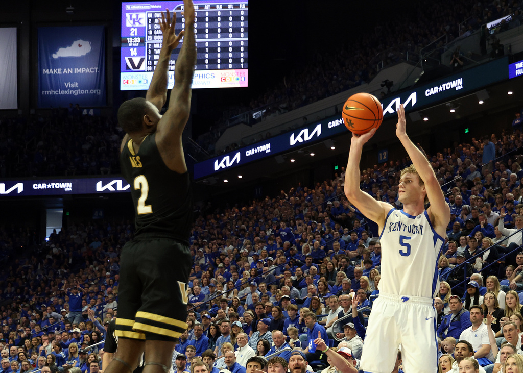 Kentucky's Collin Chandler (5) shoots a 3-point shot over Vanderbilt's Duke Miles (2) during the first half of an NCAA college basketball game in Lexington, Ky., Saturday, Feb. 28, 2026. (AP Photo/James Crisp)