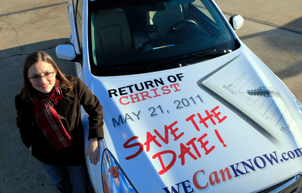 FILE - Allison Warden poses with her car in Raleigh, N.C., Dec. 17, 2010, showing a message about the rapture. (AP Photo/Gerry Broome, File)