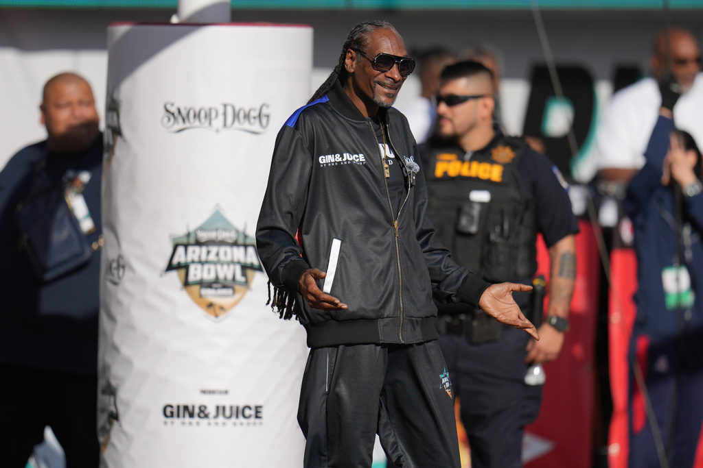 Snoop Dogg reacts after a kick off in the first half of the Snoop Dogg Arizona Bowl NCAA college football game between Fresno State and Miami, Saturday, Dec. 27, 2025, in Tucson, Ariz. (AP Photo/Rick Scuteri)