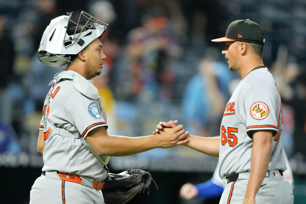 Baltimore Orioles catcher Samuel Basallo, left, and relief pitcher Cameron Foster celebrate after their baseball game against the Kansas City Royals, Monday, April 20, 2026, in Kansas City, Mo. (AP Photo/Charlie Riedel)