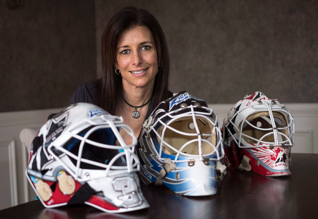 FILE - Former professional goaltender Manon Rheaume poses for a photograph with three of her masks Wednesday, Nov. 2, 2016 in Detroit. (Paul Chiasson/The Canadian Press via AP)