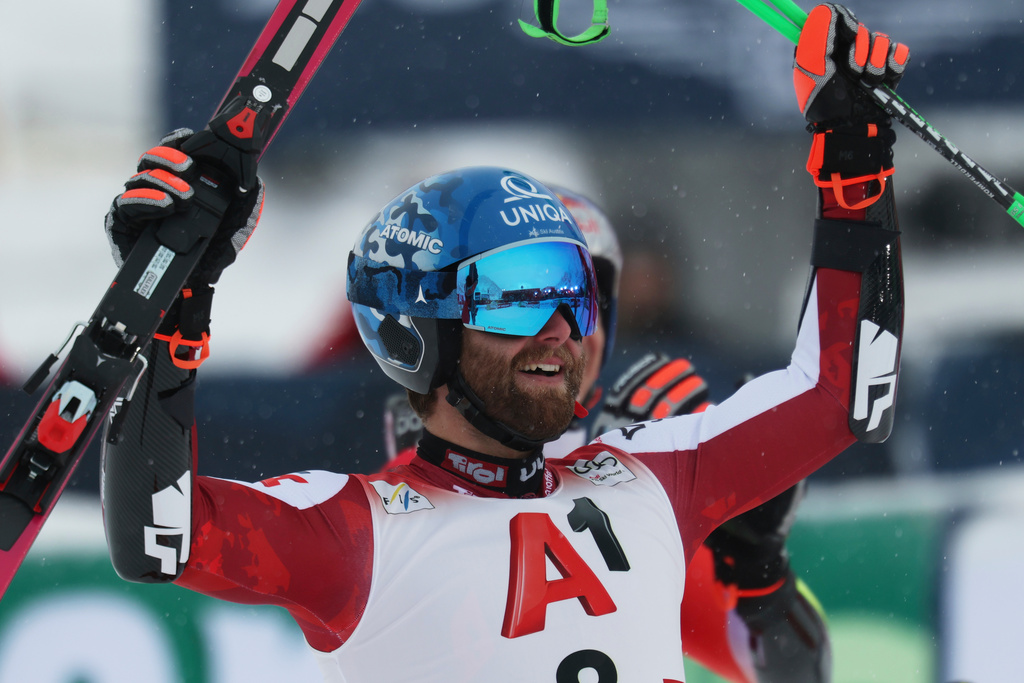 Austria's Marco Schwarz celebrates at the finish area of an alpine ski, men's World Cup giant slalom, in Soelden, Austria, Sunday, Oct. 26, 2025. (AP Photo/Alessandro Trovati)