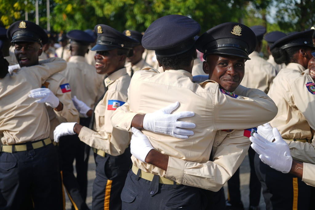 New members of the National Police force celebrate after their graduation ceremony at the Police Academy in Port-au-Prince, Haiti, Friday, Jan. 23, 2026. (AP Photo/Odelyn Joseph)