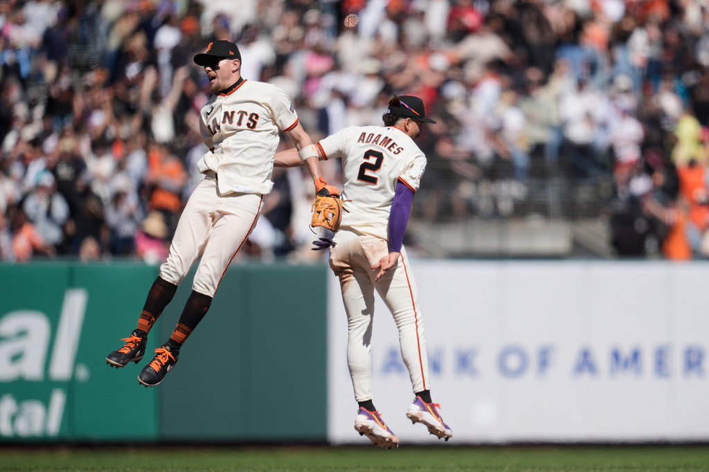 San Francisco Giants' Christian Koss, left, celebrates with Willy Adames after a baseball game against the Philadelphia Phillies in San Francisco, Wednesday, April 8, 2026. (AP Photo/Jeff Chiu)