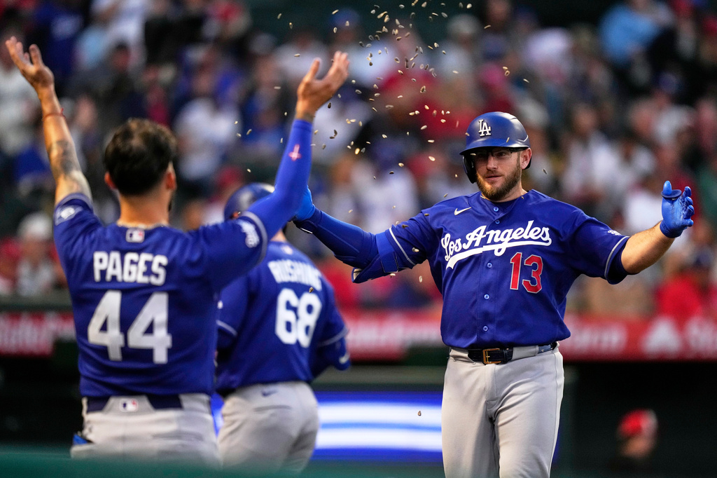 Los Angeles Dodgers' Max Muncy, right, has seeds thrown at him by Andy Pages after hitting a solo home run during the fourth inning of a baseball game against the Los Angeles Angels, Friday, May 15, 2026, in Anaheim, Calif. (AP Photo/Mark J. Terrill)