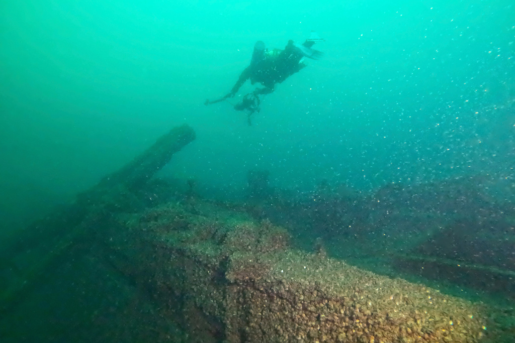 In this photo released by the Wisconsin Historical Society, Wisconsin Historical Society diver Zach Whitrock collects images of the wreckage of the schooner F.J. King for a photo model on Aug. 23, 2025. (Wisconsin Historical Society via AP)