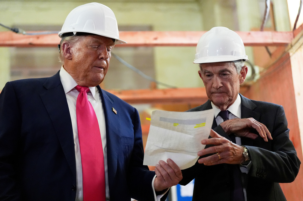 FILE- FILE - Federal Reserve Chairman Jerome Powell, right, and President Donald Trump look over a document of cost figures during a visit to the Federal Reserve, Thursday, July 24, 2025, in Washington. (AP Photo/Julia Demaree Nikhinson, File)