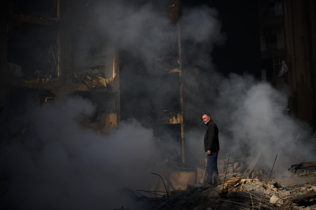 A man stands next to an apartment building destroyed in an Israeli airstrike a day earlier in Beirut, Lebanon, Thursday, April 9, 2026. (AP Photo/Emilio Morenatti)