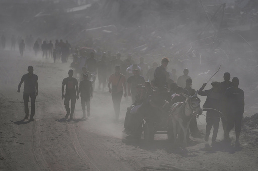 Displaced Palestinians walk past destroyed buildings as they return to their homes in the Zeitoun neighborhood of Gaza City, Friday, Oct. 10, 2025, after Israel and Hamas agreed to a pause in their war and the release of remaining hostages. (AP Photo/Jehad Alshrafi) Displaced Palestinians walk past destroyed buildings as they return to their homes in the Zeitoun neighborhood of Gaza City, Friday, Oct. 10, 2025, after Israel and Hamas agreed to a pause in their war and the release of remaining hostages. (AP Photo/Jehad Alshrafi)