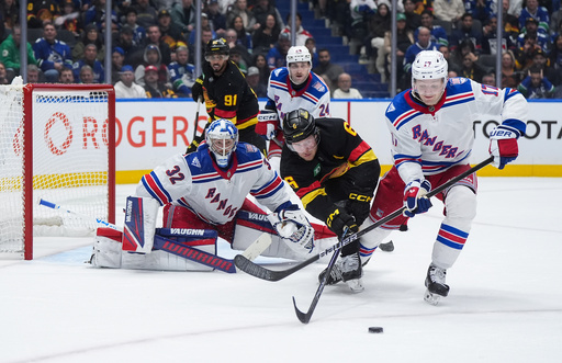 Vancouver Canucks' Brock Boeser (6) and New York Rangers' Will Borgen (17) vie for the puck after goalie Jonathan Quick (32) made the save during the third period of an NHL hockey game, in Vancouver, on Tuesday, Oct. 28, 2025. (Darryl Dyck/The Canadian Press via AP) Vancouver Canucks' Brock Boeser (6) and New York Rangers' Will Borgen (17) vie for the puck after goalie Jonathan Quick (32) made the save during the third period of an NHL hockey game, in Vancouver, on Tuesday, Oct. 28, 2025. (Darryl Dyck/The Canadian Press via AP)