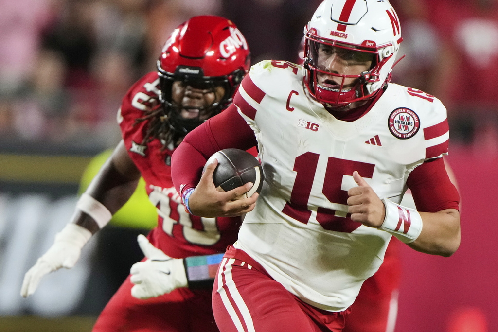 Cincinnati defensive lineman Kamari Burns (40) chases Nebraska quarterback Dylan Raiola (15) during the second half of an NCAA college football game Thursday, Aug. 28, 2025, at Arrowhead Stadium in Kansas City, Mo. (AP Photo/Charlie Riedel)