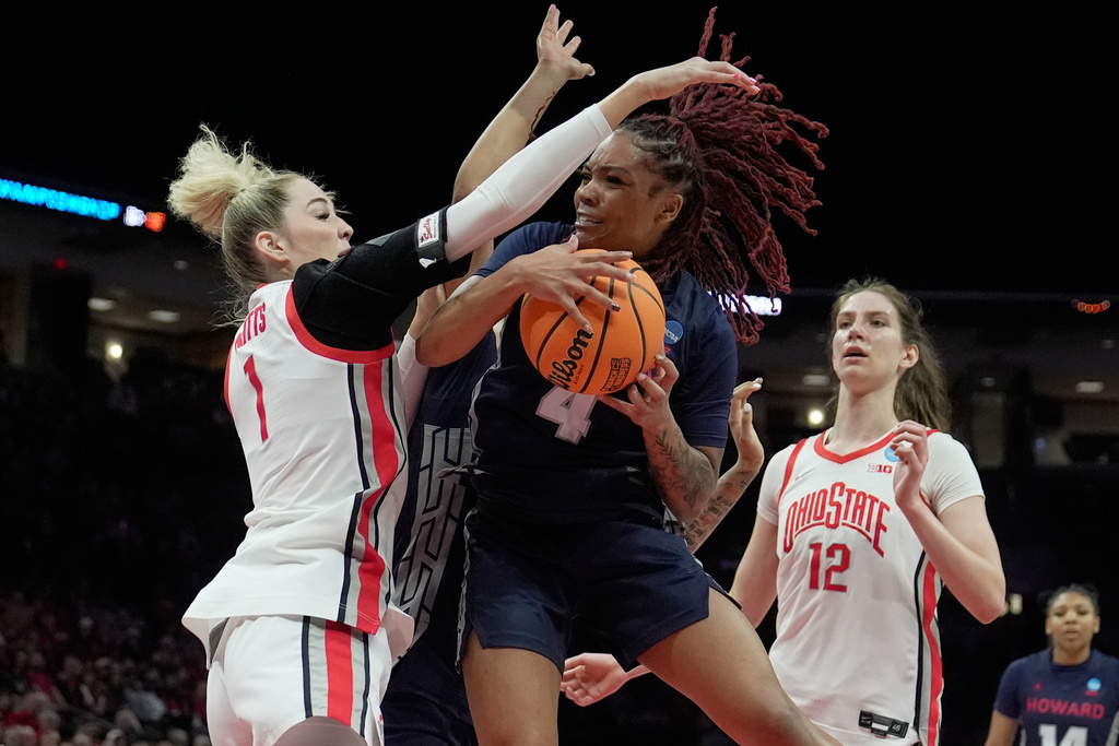 Howard guard Ariella Henigan (4) grabs a rebound between Ohio State forward Kylee Kitts (1) and center Elsa Lemmilä (12) in the first half in the first round of the NCAA college basketball tournament, Saturday, March 21, 2026, in Columbus, Ohio. (AP Photo/Sue Ogrocki)