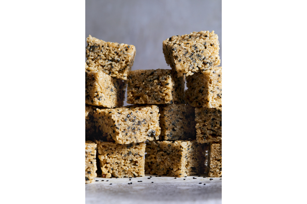 This image released by Voracious shows a recipe for black sesame and brown butter rice krispie treats from the cookbook "108 Asian Cookies" by Kat Lieu. (Charity Burggraaf/Voracious via AP)