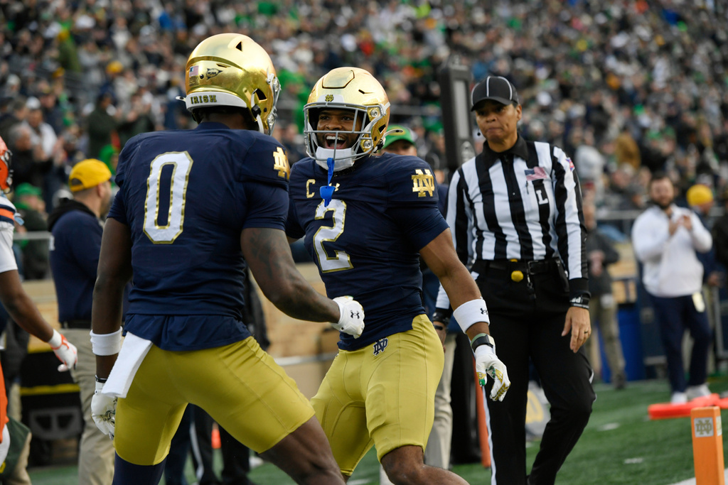 Notre Dame wide receiver Will Pauling (2) celebrates with teammate Malachi Fields (0) after catching a touchdown pass during the first quarter of an NCAA football game against Syracuse, Saturday, Nov. 22, 2025, in South Bend, Ind. (AP Photo/Paul Beaty)