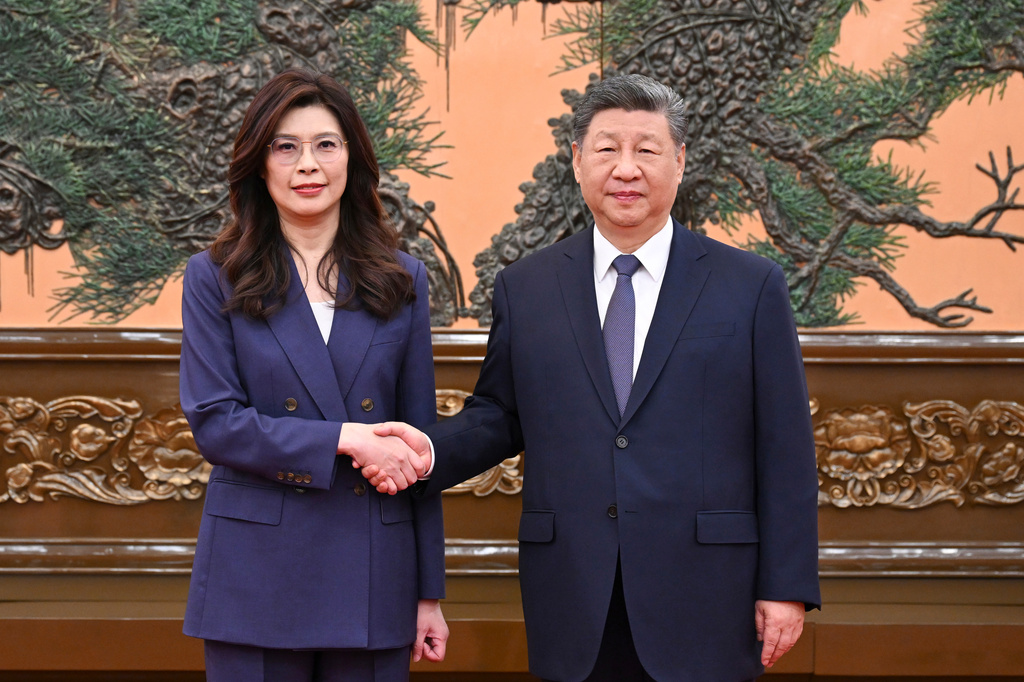 In this photo released by Xinhua News Agency, Chinese President Xi Jinping, right shakes hands with Kuomintang (KMT) party leader Cheng Li-wun in Beijing on Friday, April 10, 2026. (Xie Huanchi/Xinhua via AP)