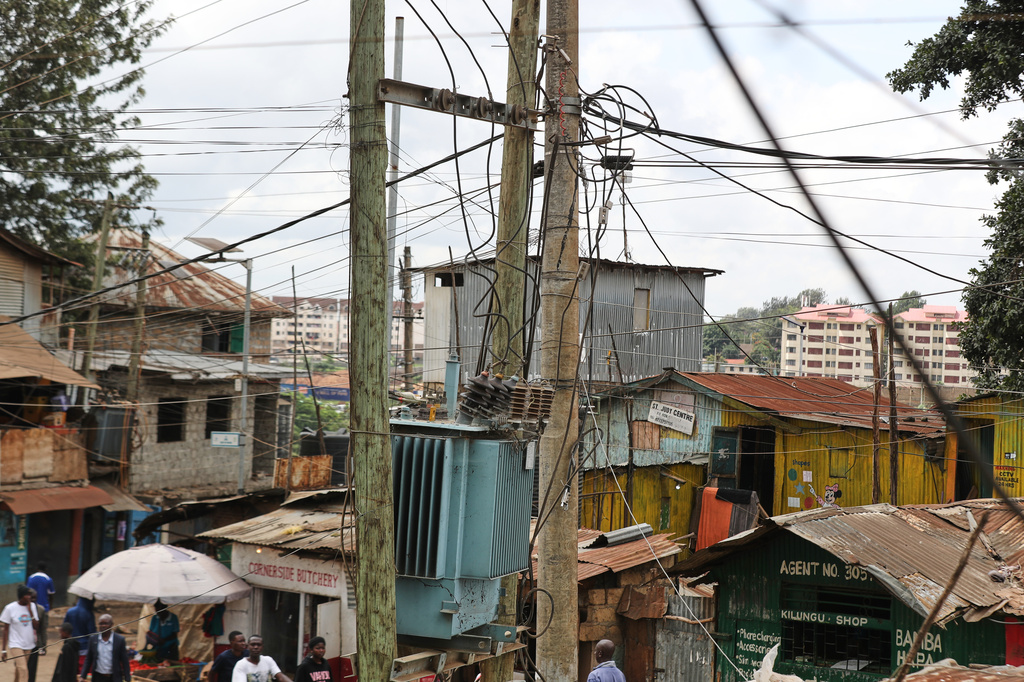 A view of electric wire poles and cables towering over the Kibera informal settlement in Nairobi, Kenya, Tuesday, March 31, 2026. (AP Photo/Henry Naminde)