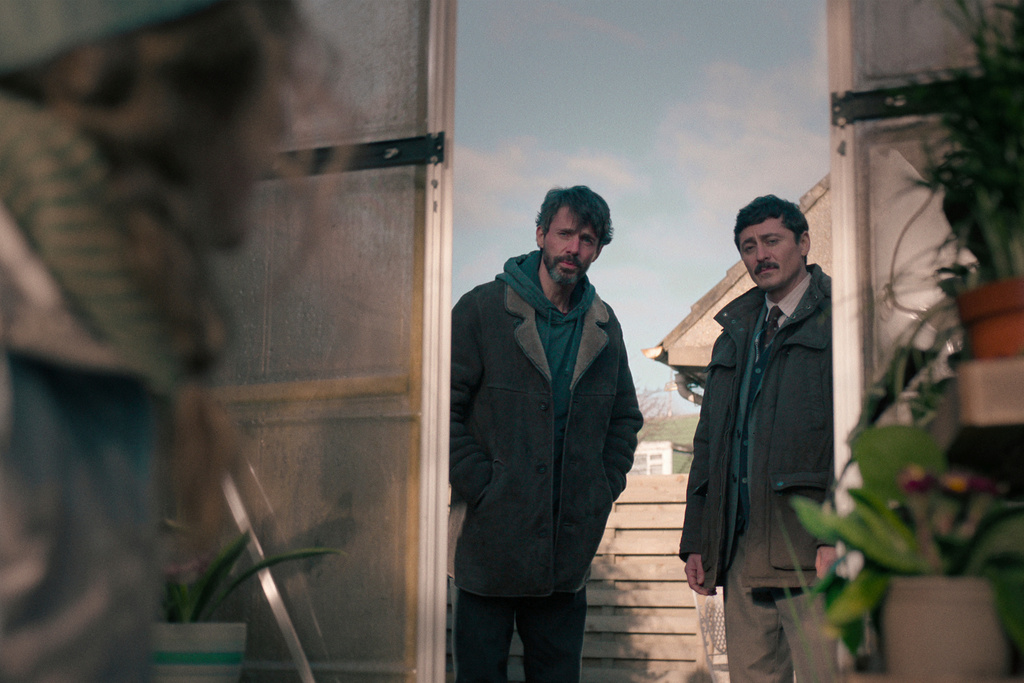 This image released by Netflix shows Matthew Goode, left, and Alexej Manvelov in a scene from the series "Dept. Q." (Netflix via AP)
