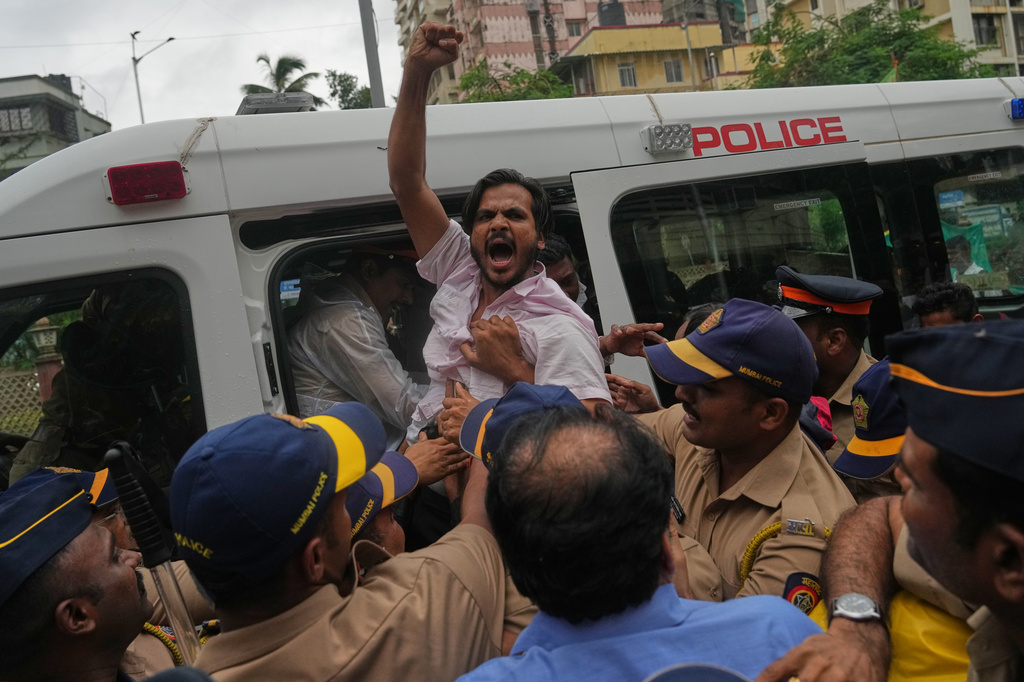Police detain a supporter of the Cockroach Janta Party during a protest demanding the resignation of India's education minister in Mumbai, India, Monday, July 20, 2026.(AP Photo/Rafiq Maqbool)